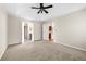 Bright carpeted bedroom featuring neutral paint, ceiling fan, and access to both bath and an office or closet at 1452 Evanston Ln, Marietta, GA 30062