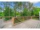 Spacious wooden deck offering serene views of the surrounding landscape with lush trees at 1452 Evanston Ln, Marietta, GA 30062