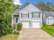 Charming two-story home with blue siding, a stone accent wall and a two-car garage at 1452 Evanston Ln, Marietta, GA 30062