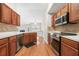 Modern kitchen with stainless steel appliances, light counter tops, and wood cabinetry at 1452 Evanston Ln, Marietta, GA 30062
