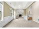 Spacious living area with arched doorways, plush carpet, and tray ceiling in neutral tones at 1452 Evanston Ln, Marietta, GA 30062