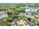 Aerial view of the property surrounded by lush greenery, showcasing the neighborhood and proximity to a lake at 2602 Midler Ct, Buford, GA 30519