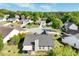 Bird's-eye view showcasing the home's setting within a quiet neighborhood, complete with mature trees and manicured lawns at 2602 Midler Ct, Buford, GA 30519