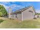 Spacious backyard featuring a covered patio and lush green grass at 2602 Midler Ct, Buford, GA 30519