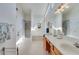 Spacious primary bathroom with double sinks, tiled floors, shower, garden tub, and ample natural light at 2602 Midler Ct, Buford, GA 30519