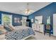 This bedroom features a blue accent wall, queen bed, modern dresser, and a ceiling fan providing comfort and style at 2602 Midler Ct, Buford, GA 30519
