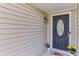 Charming front door with decorative glass, enhanced by a welcome mat and potted plants for added curb appeal at 2602 Midler Ct, Buford, GA 30519