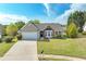 Inviting one-story home featuring a well-manicured lawn, brick accents, bay window, and a convenient two-car garage at 2602 Midler Ct, Buford, GA 30519