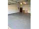 Well-kept garage interior, providing secure parking and extra storage with built-in shelving and cabinet space at 2602 Midler Ct, Buford, GA 30519
