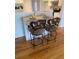 Charming kitchen island featuring a light wood top, white cabinets, and seating for two at 2602 Midler Ct, Buford, GA 30519