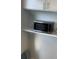 A modern microwave situated on a shelf, conveniently placed near cabinets and countertops in the kitchen area at 2602 Midler Ct, Buford, GA 30519