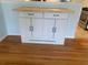 White kitchen island with solid surface top and black hardware in a kitchen area at 2602 Midler Ct, Buford, GA 30519