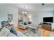 A comfortable living room with hardwood floors and ample seating, creating a warm and inviting space for relaxation at 2602 Midler Ct, Buford, GA 30519