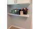 Shelf with microwave, flowers, and picture frame in an open kitchen area at 2602 Midler Ct, Buford, GA 30519