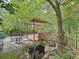 Backyard featuring wooden deck with pergola, patio, and a small fish pond at 3220 Stoney Acres Nw Dr, Kennesaw, GA 30152
