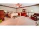 Large bedroom features a ceiling fan, and classic wood furniture with an inviting sitting area at 3220 Stoney Acres Nw Dr, Kennesaw, GA 30152