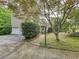 Home exterior featuring mature trees, attached garage, and a walkway to the front door at 3220 Stoney Acres Nw Dr, Kennesaw, GA 30152