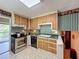 Bright kitchen with stainless steel appliances, wooden cabinets, and a view to the backyard at 3220 Stoney Acres Nw Dr, Kennesaw, GA 30152