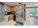 Functional kitchen with wooden cabinets, stainless steel refrigerator, and an eat-in area at 3220 Stoney Acres Nw Dr, Kennesaw, GA 30152