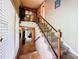 Interior shot of a carpeted staircase with wooden railings and a view into the living space at 3220 Stoney Acres Nw Dr, Kennesaw, GA 30152