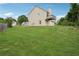 Large backyard features a green lawn, a private balcony, and mature trees at 5447 Lauren Cv, Ellenwood, GA 30294