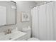 Clean bathroom features a white vanity, framed mirror, and shower with a white curtain at 5447 Lauren Cv, Ellenwood, GA 30294