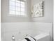Relaxing bathroom with white tile and a soaking tub under a bright window at 5447 Lauren Cv, Ellenwood, GA 30294