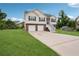 Charming two-story home with brick and vinyl siding and a spacious front yard with a long driveway at 5447 Lauren Cv, Ellenwood, GA 30294