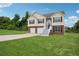 Charming two-story home with brick and vinyl siding, manicured lawn, and a two-car garage at 5447 Lauren Cv, Ellenwood, GA 30294