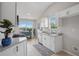 Bright kitchen with white cabinetry, stainless steel appliances, granite countertops, and tile flooring at 5447 Lauren Cv, Ellenwood, GA 30294