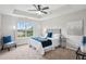 Serene bedroom featuring tray ceilings, soft carpet, a large window, and neutral decor at 5447 Lauren Cv, Ellenwood, GA 30294