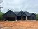 A charming, single-story home featuring a dark gray exterior, an attached garage, and a well-manicured lawn at 816 Proctor Rd, Rockmart, GA 30153