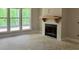 Bright living room featuring a modern fireplace, mantle and large windows offering natural light at 816 Proctor Rd, Rockmart, GA 30153