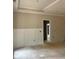 Living room with wainscoting, neutral paint, and white trim offering a bright and spacious area at 816 Proctor Rd, Rockmart, GA 30153