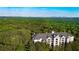 Stunning aerial view of condo building surrounded by trees with distant city skyline backdrop at 4100 Paces Se Walk # 4306, Atlanta, GA 30339