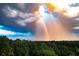 Breathtaking aerial view showcasing a double rainbow over lush trees and a distant city skyline at 4100 Paces Se Walk # 4306, Atlanta, GA 30339