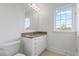 Neat bathroom featuring a granite vanity with sink and a nearby window at 4100 Paces Se Walk # 4306, Atlanta, GA 30339