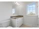 Well-lit bathroom featuring a single sink vanity, granite countertop, and wainscoting at 4100 Paces Se Walk # 4306, Atlanta, GA 30339