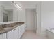 Well-lit bathroom with granite countertops, double sinks, and white cabinetry at 4100 Paces Se Walk # 4306, Atlanta, GA 30339