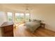Bright bedroom featuring hardwood floors, a ceiling fan, and multiple windows with beautiful outdoor views at 4100 Paces Se Walk # 4306, Atlanta, GA 30339