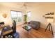 Bright bedroom featuring hardwood floors, large windows and a cozy sitting area with modern desk and light gray loveseat at 4100 Paces Se Walk # 4306, Atlanta, GA 30339