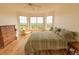 Comfortable bedroom featuring hardwood floors, a ceiling fan, and multiple windows with beautiful outdoor views at 4100 Paces Se Walk # 4306, Atlanta, GA 30339