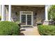 Elegant building entrance with stone facade, stately columns, and manicured landscaping at 4100 Paces Se Walk # 4306, Atlanta, GA 30339