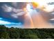 Scenic exterior view showcases the community's lush green landscape with a vibrant double rainbow after rainfall at 4100 Paces Se Walk # 4306, Atlanta, GA 30339