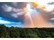 Scenic landscape view featuring a vibrant double rainbow over lush trees and distant skyline at 4100 Paces Se Walk # 4306, Atlanta, GA 30339