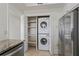Bright laundry room with a stacked washer and dryer and shelving, conveniently located off the kitchen at 4100 Paces Se Walk # 4306, Atlanta, GA 30339