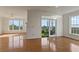 Spacious, open-concept living room features hardwood floors and a patio with views beyond at 4100 Paces Se Walk # 4306, Atlanta, GA 30339