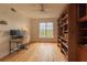 A well-lit office features a large bookcase, hardwood floors, and natural light at 4100 Paces Se Walk # 4306, Atlanta, GA 30339