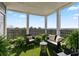 Inviting covered patio with seating area, lush plants, and a view of the landscape and city skyline at 4100 Paces Se Walk # 4306, Atlanta, GA 30339