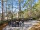Inviting brick patio with outdoor seating, a fire pit, grill, and surrounded by lush trees in a serene backyard setting at 4100 Paces Se Walk # 4306, Atlanta, GA 30339